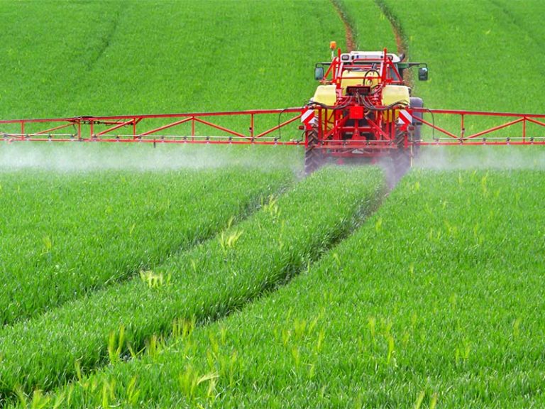 FArmer spreading nitrogen fertilizer