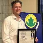 Justin Williams holds a plaque commemorating his induction into the Cobourg Sports Hall of Fame.