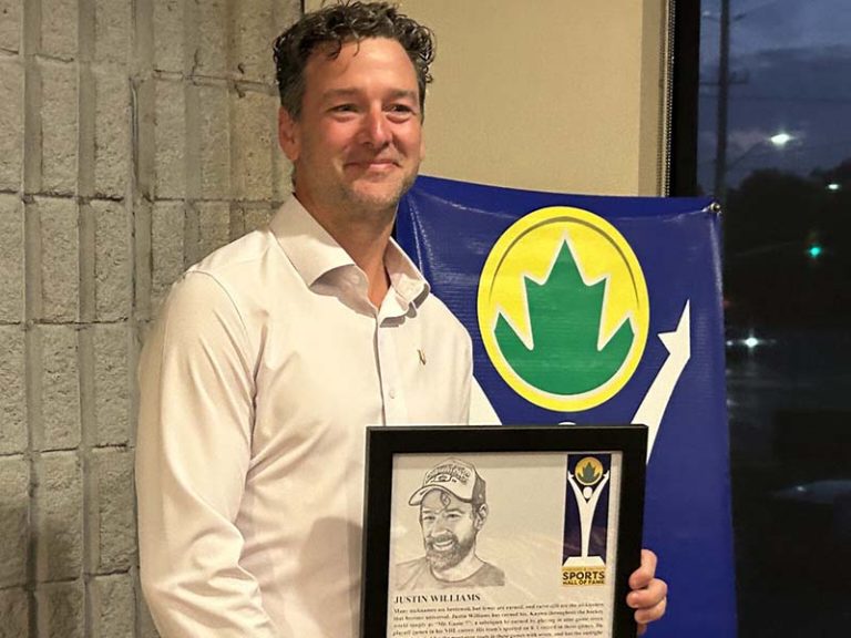 Justin Williams holds a plaque commemorating his induction into the Cobourg Sports Hall of Fame.