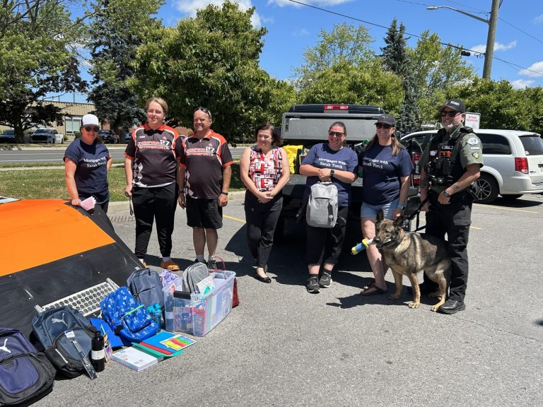 Sarah Turck (third from right) is challenging Port Hope residents to fill her truck with school supplies. By Dan Jones, CFWN, LJI Play