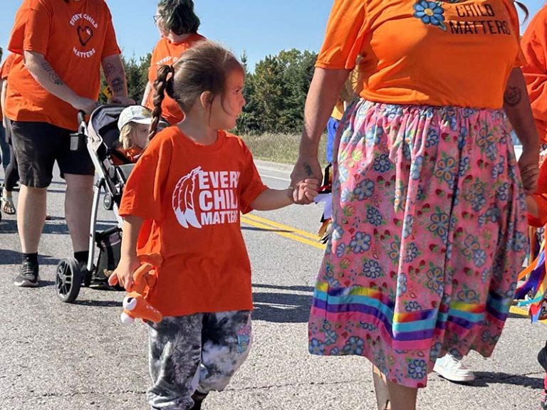A child walking during National Day for Truth and Reconciliation on the Alderville First Nation. Photo by Dan Jones, CFWN, LJI Play