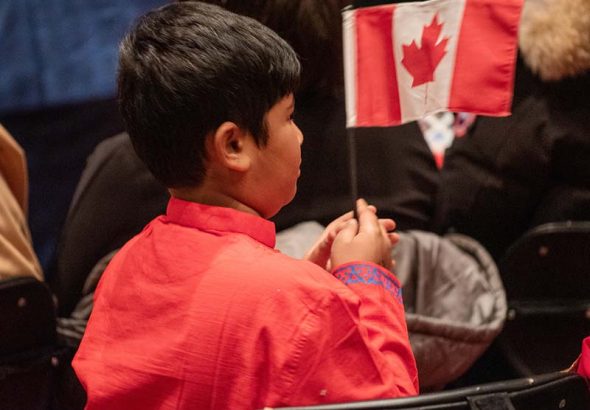 Immigration Boy holding Canada Flag