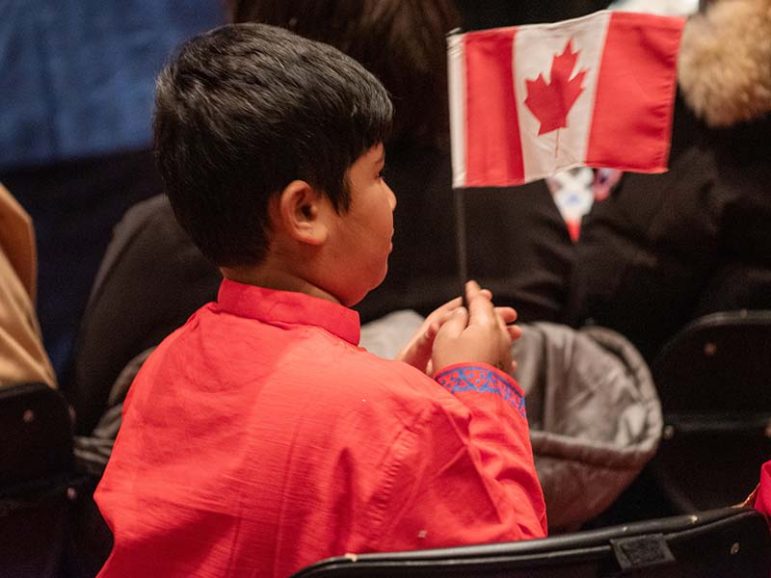 Immigration Boy holding Canada Flag