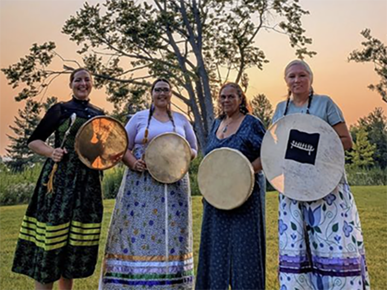 The traditional women's hand-drumming group, Naandewegaan, Healing with Drums, will perform at the International Women's Day even on Saturday, March 7, 2026 in Peterborough. The group is Janet McCue, Zainab Amadahy, Mshkiki Gitigaan Kwe, and Serene Brennan.