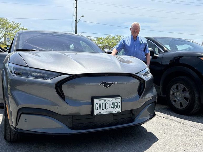 David Kunhke standing next to his Electric Ford Mustang. Photo by Dan Jones, CFWN, LJI