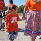 A child walking during National Day for Truth and Reconciliation on the Alderville First Nation. Photo by Dan Jones, CFWN, LJI